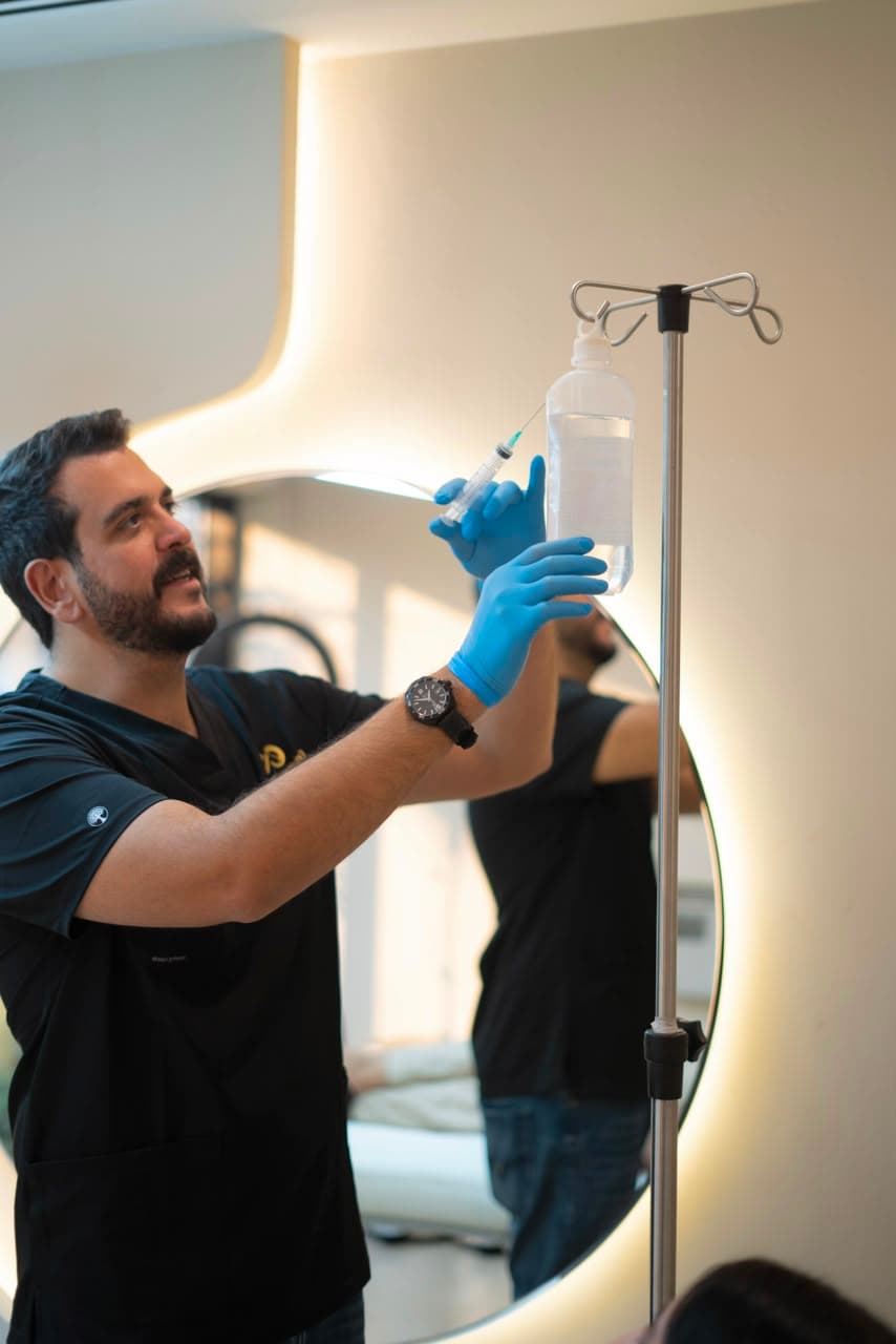Healthcare professional preparing an IV bag